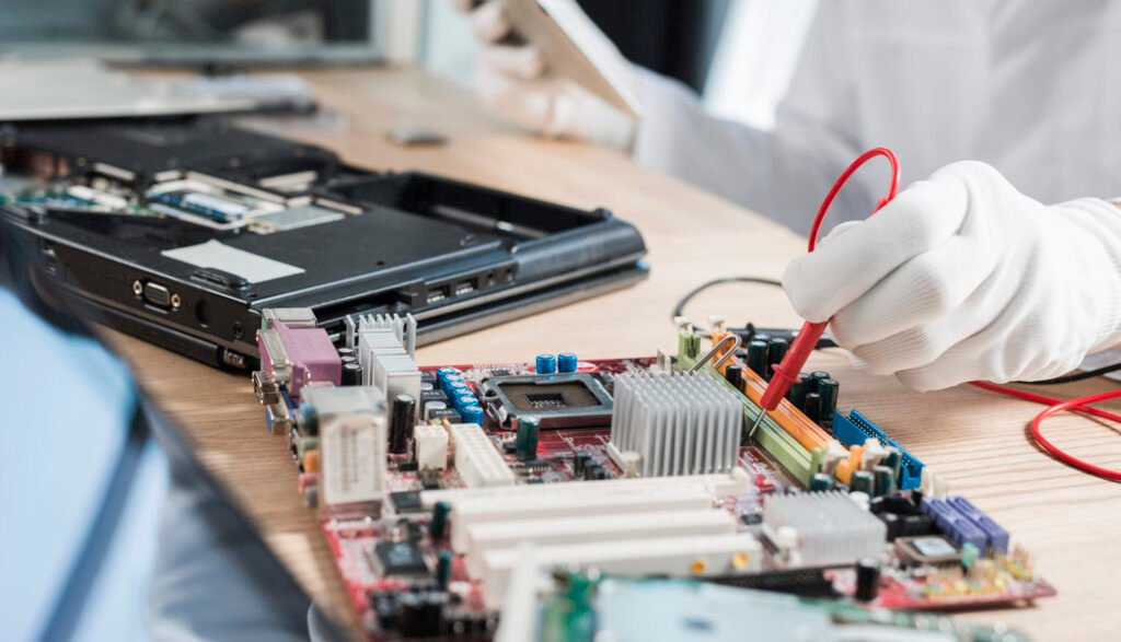 male-technician-examining-mother-board-with-digital-multimeter